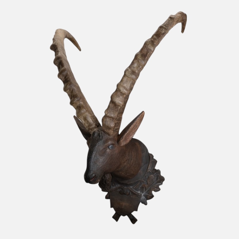 Wooden statue depicting the head of an animal, the ibex